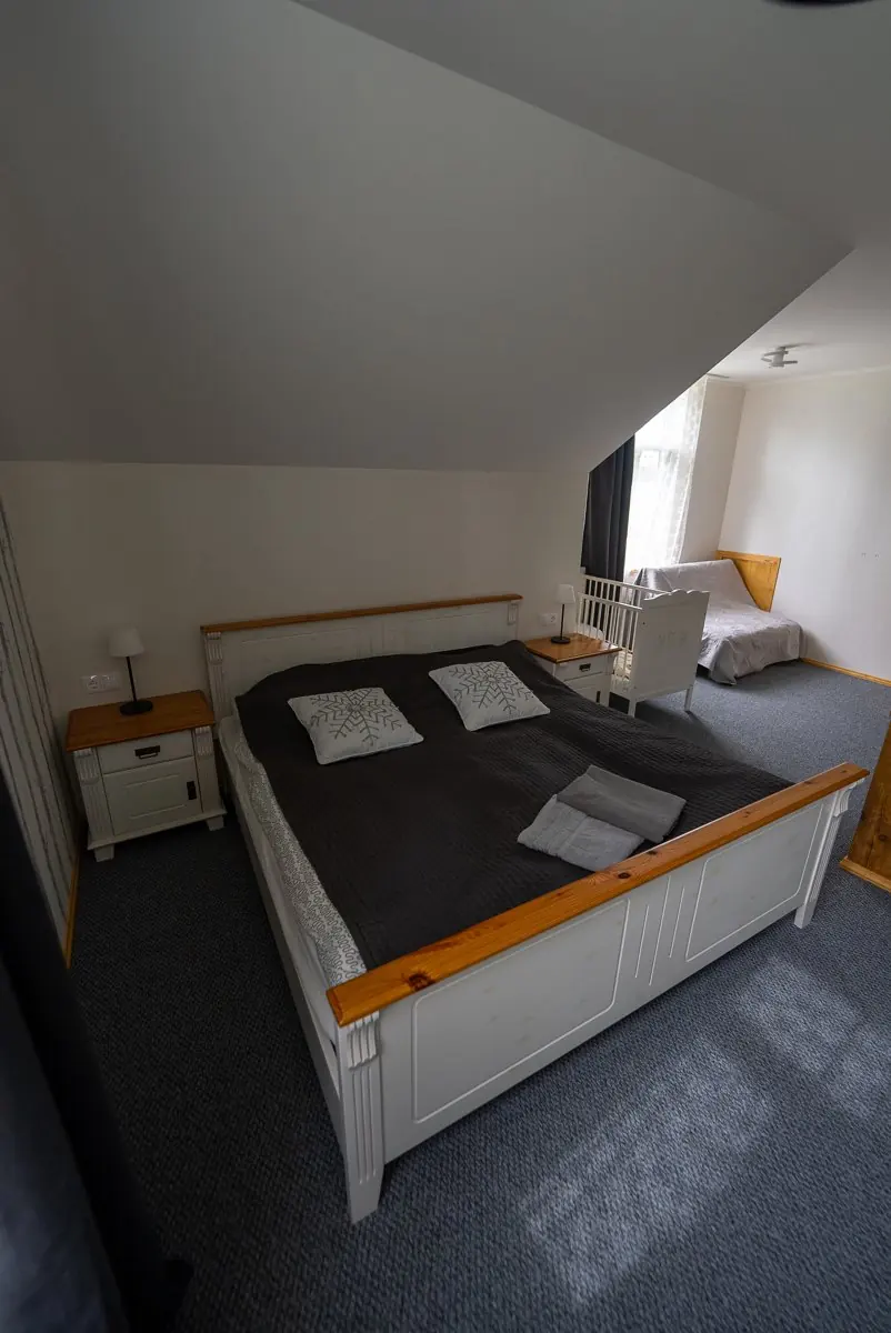 Spacious bedroom in the Õnnela host house with a white double bed