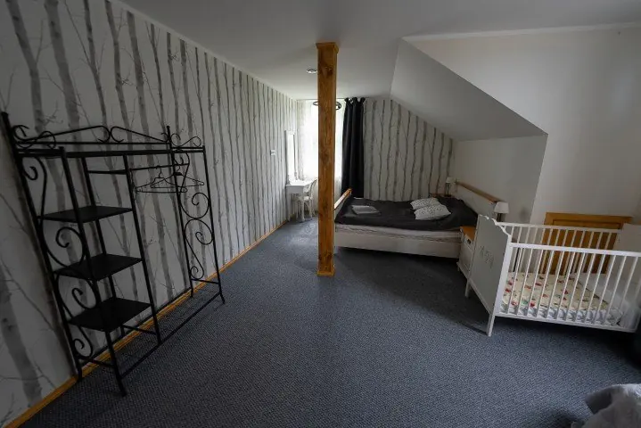 Host house family room with a double bed and a cot