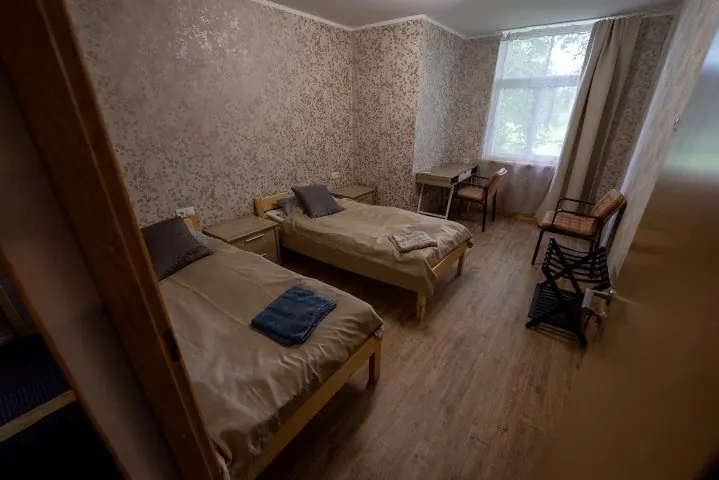 Host house room with two single beds