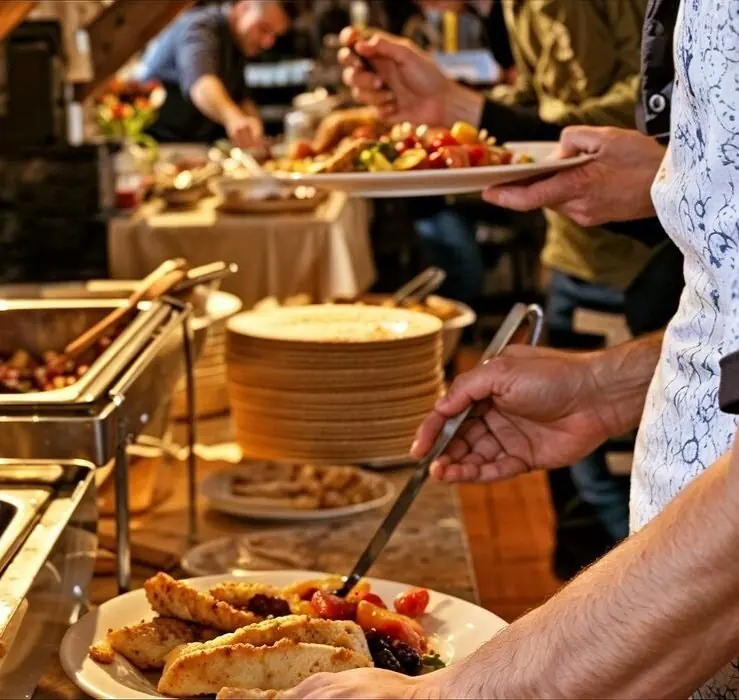 Guests serving themselves food from a buffet
